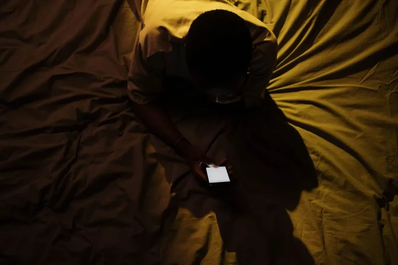 Person answering privately on their phone at home