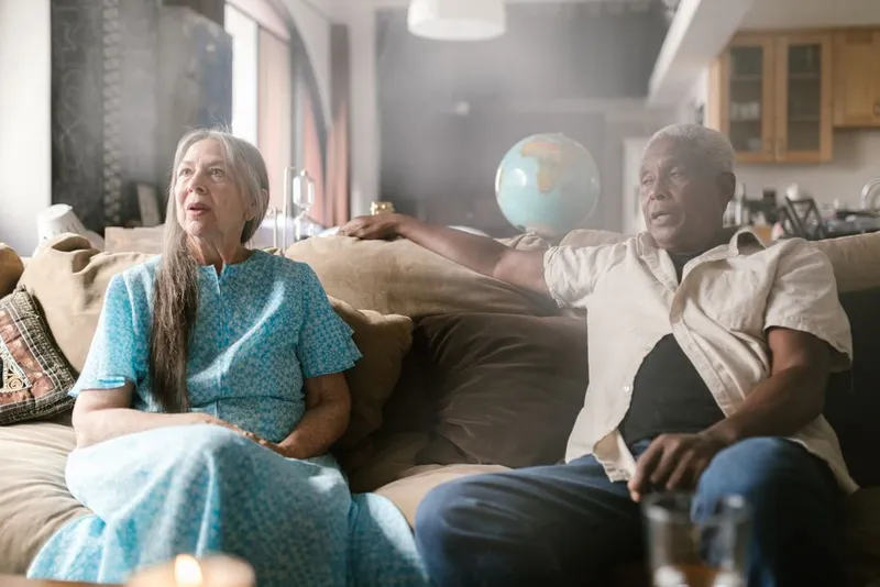 Couple in a calm, honest conversation together on a sofa