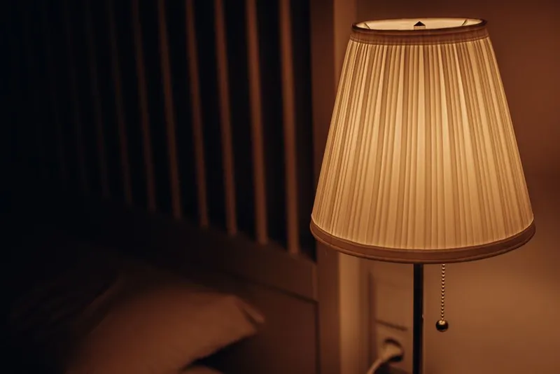 Couple close together at home in warm evening bedside light