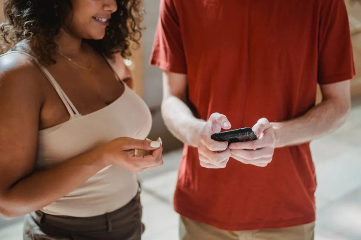 Couple using phones together in the evening