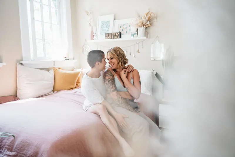 Couple sitting close together on a sofa in warm evening light
