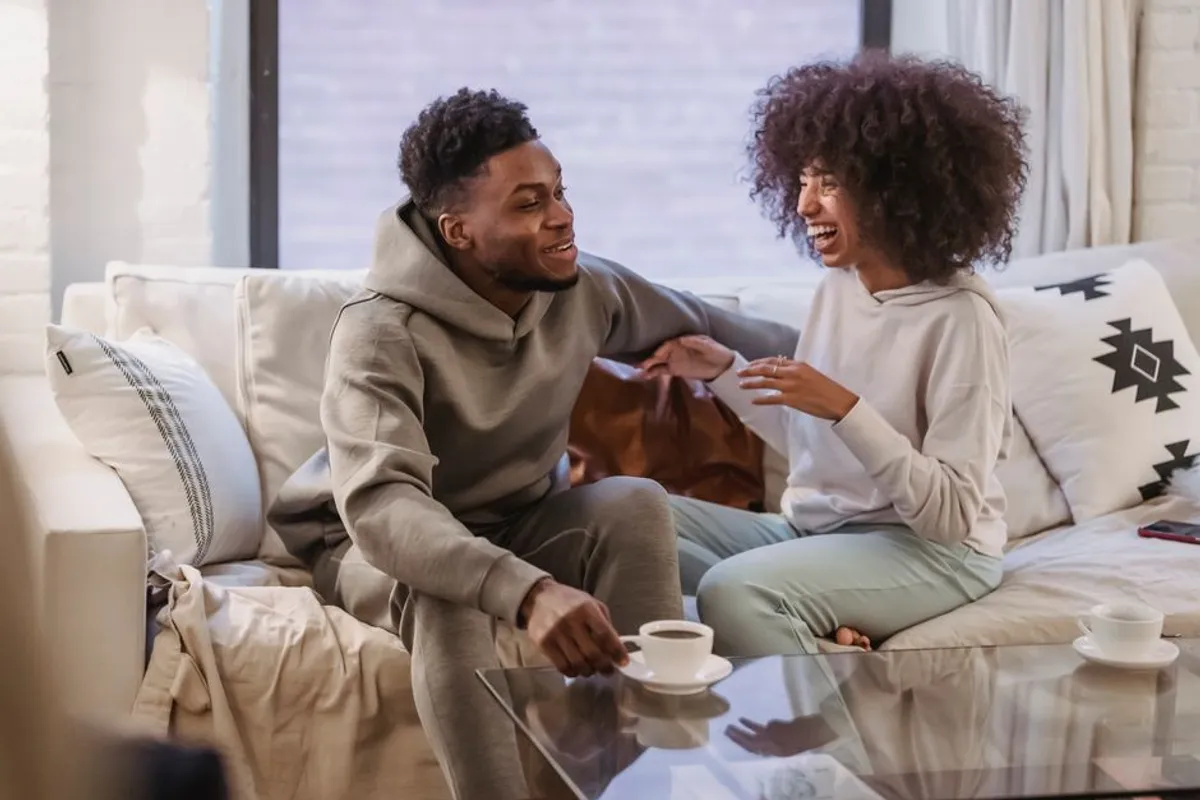 Couple in a gentle, open discussion on a sofa
