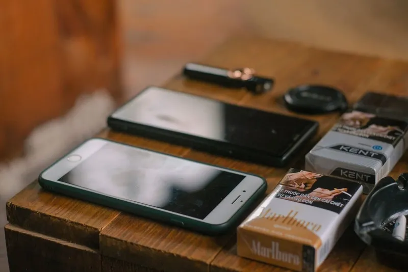 Smartphones resting on a table in a warm home setting