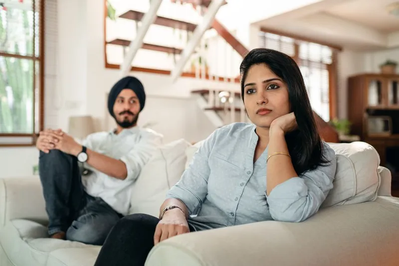 Couple in a quiet, thoughtful moment together on a sofa