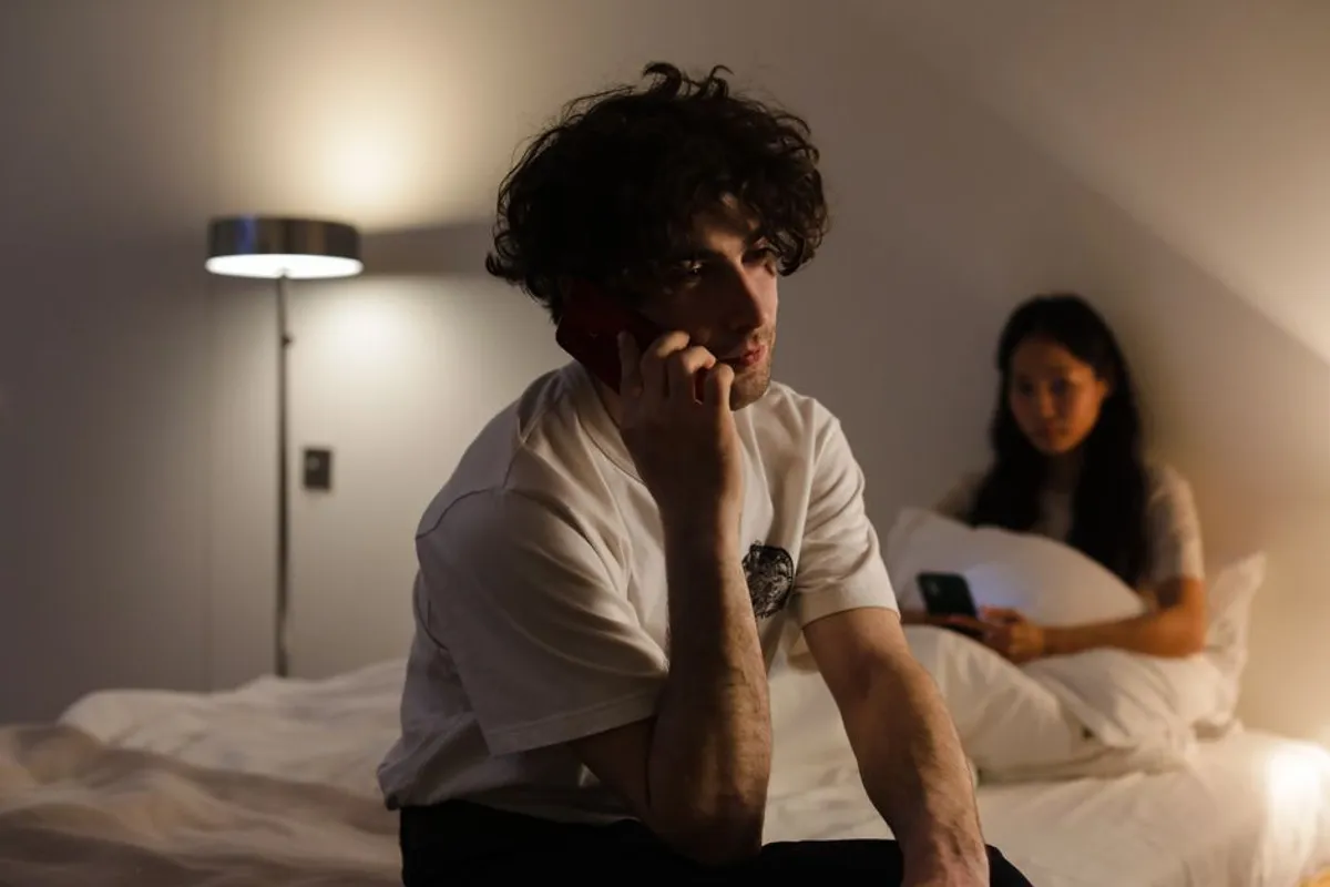 Two people answering privately on their phones at home