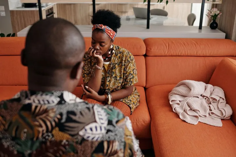 Couple in a warm, close conversation on a sofa